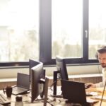 Service - Man With Headphones Facing Computer Monitor